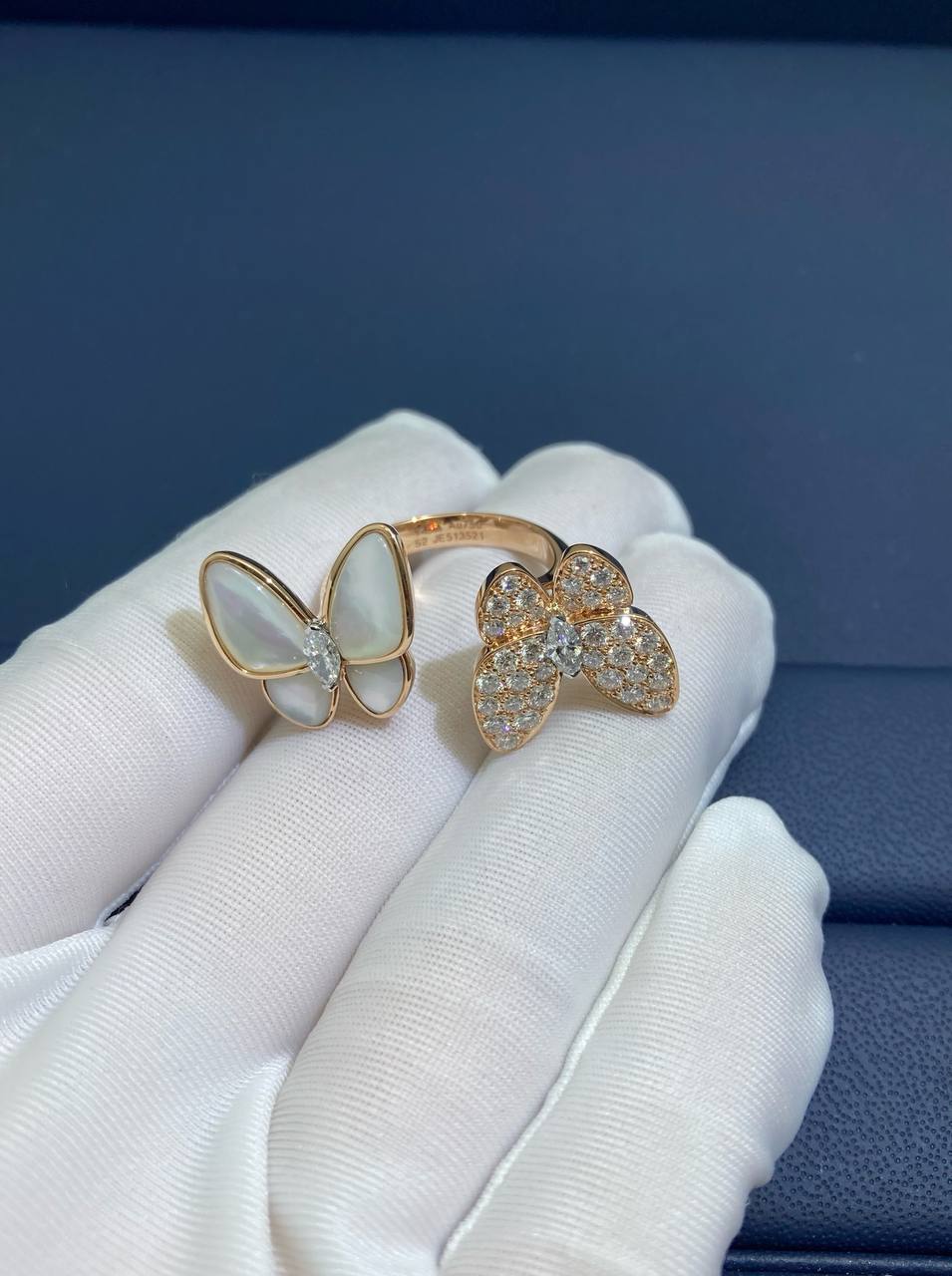 VC between the finger butterfly ring with Mother-of-Pearl and diamonds