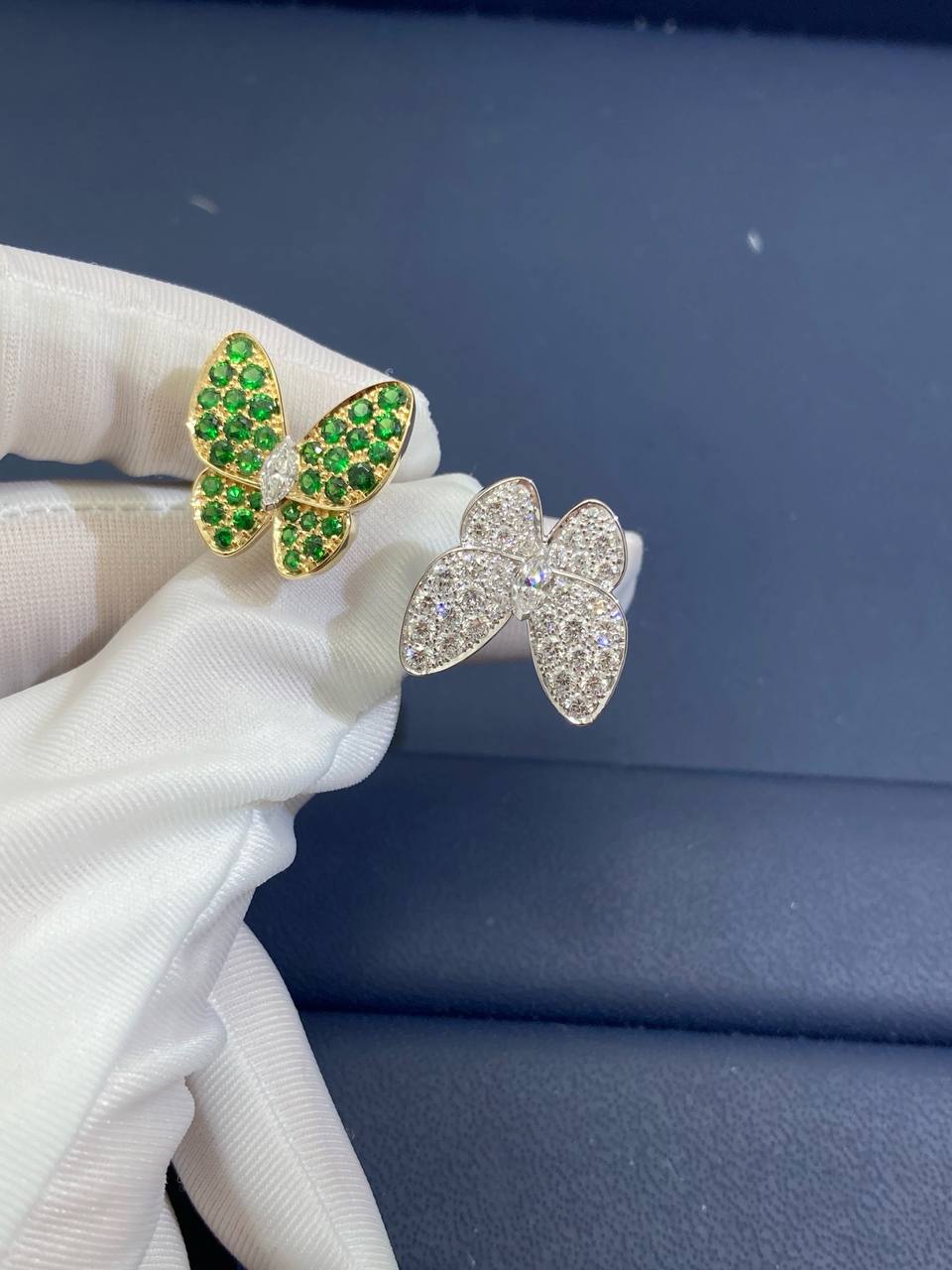 VC between the finger butterfly ring with diamonds and tsavorites