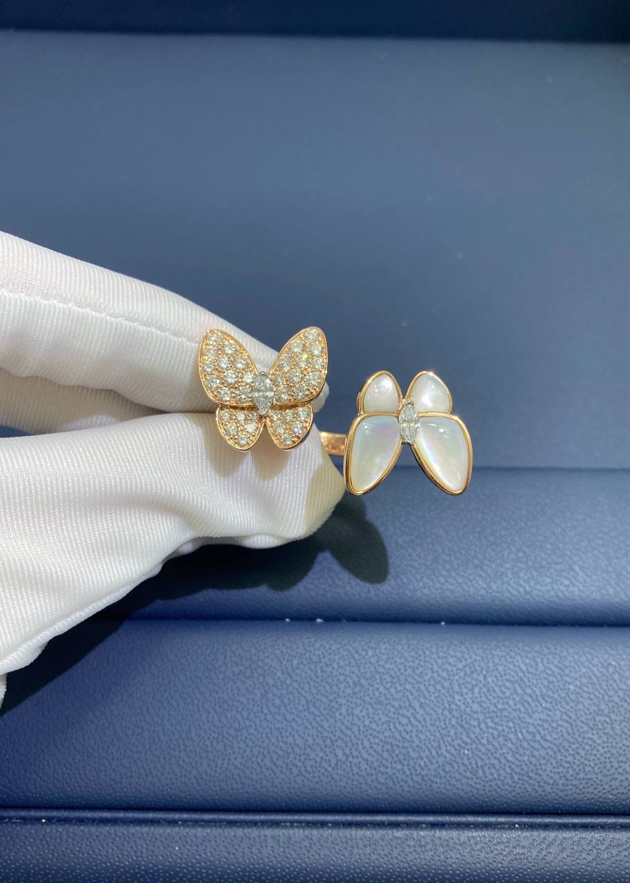 VC between the finger butterfly ring with Mother-of-Pearl and diamonds