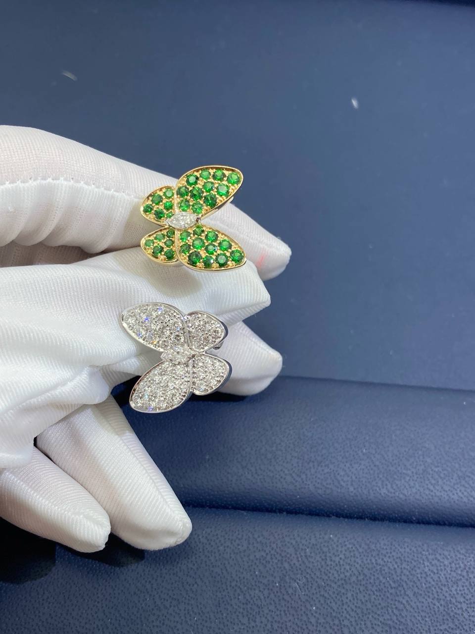 VC between the finger butterfly ring with diamonds and tsavorites