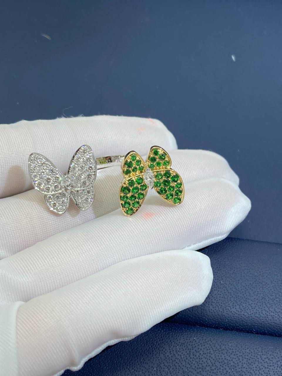 VC between the finger butterfly ring with diamonds and tsavorites